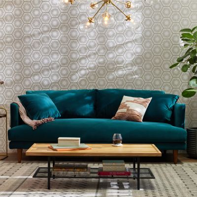 Woman relaxing on teal sofa