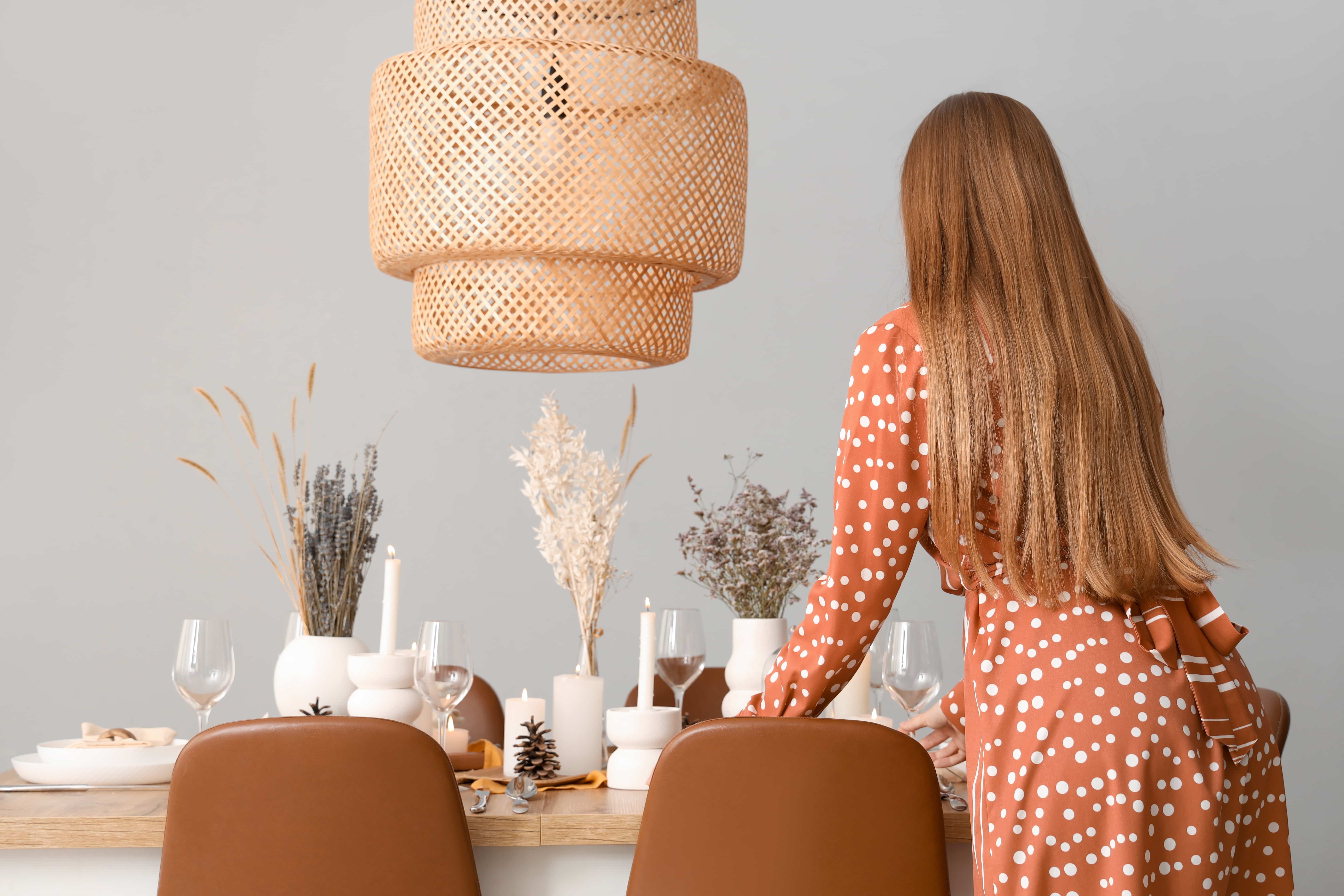 Woman at elegantly set dining table for intimate dining