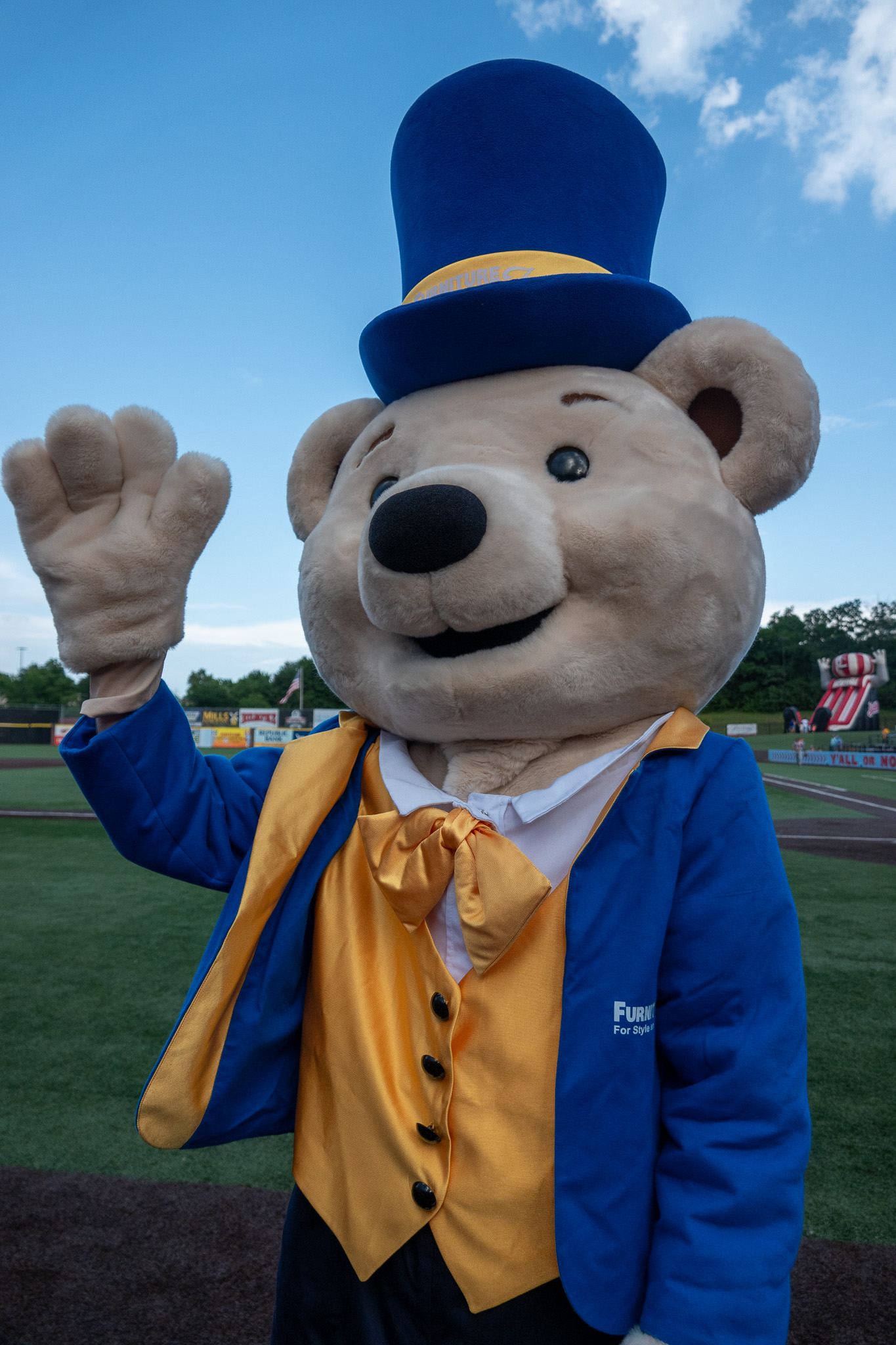 Share Bear mascot waving at a community event